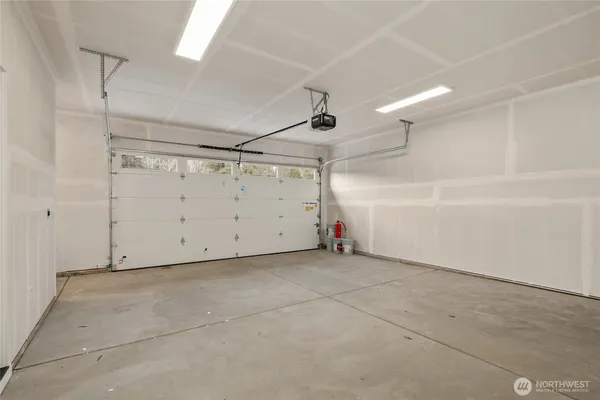 a aerial view of a house with a yard and large tree