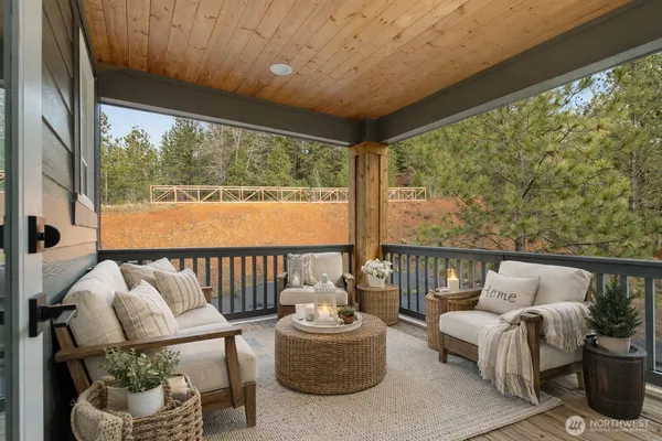 a view of a patio with a table and chairs under an umbrella