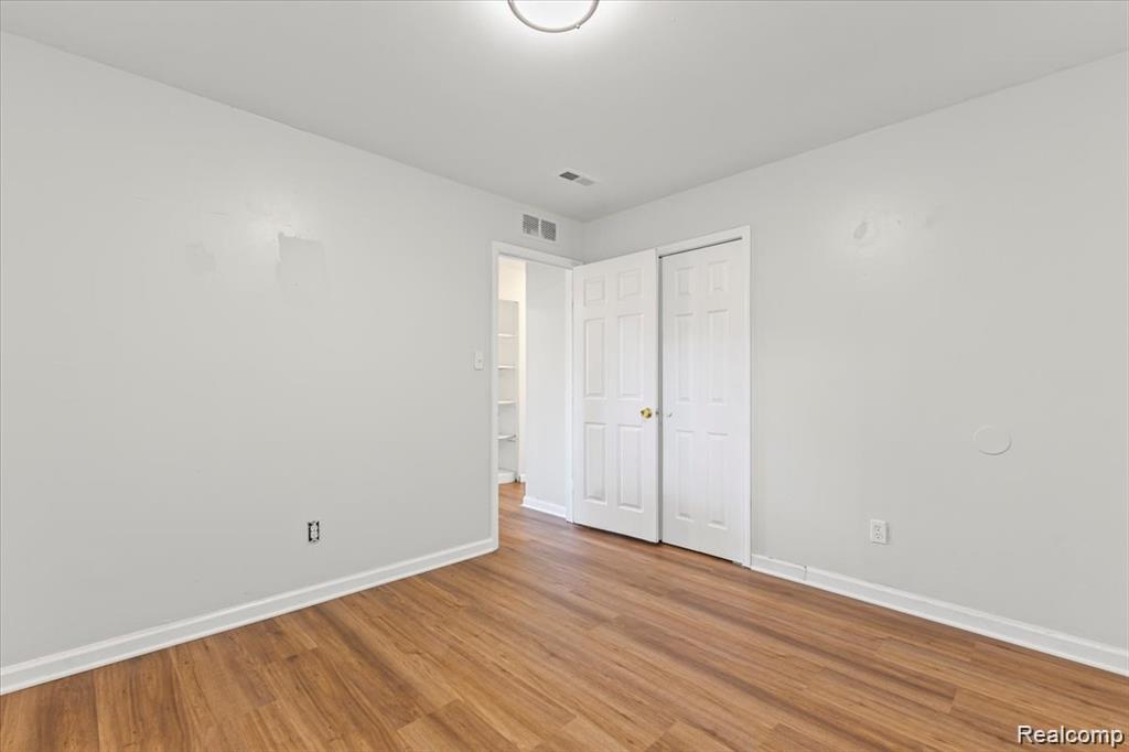 3930 Bayhan Street Inkster, MI 48141 - Photo 11 of 14 Room featuring wood-finish flooring, white baseboards, and light-colored walls