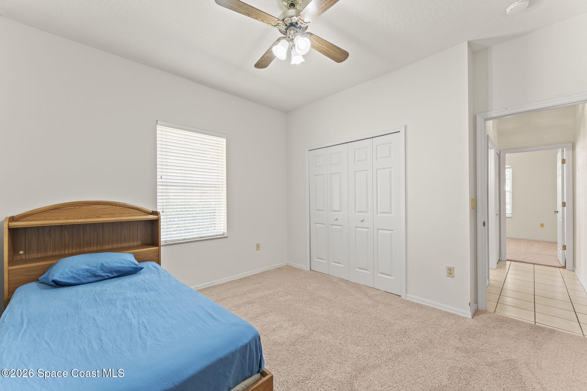 1123 Spring Oak Drive Melbourne, FL 32901 - Photo 44 of 67 a bedroom with a bed and a ceiling fan