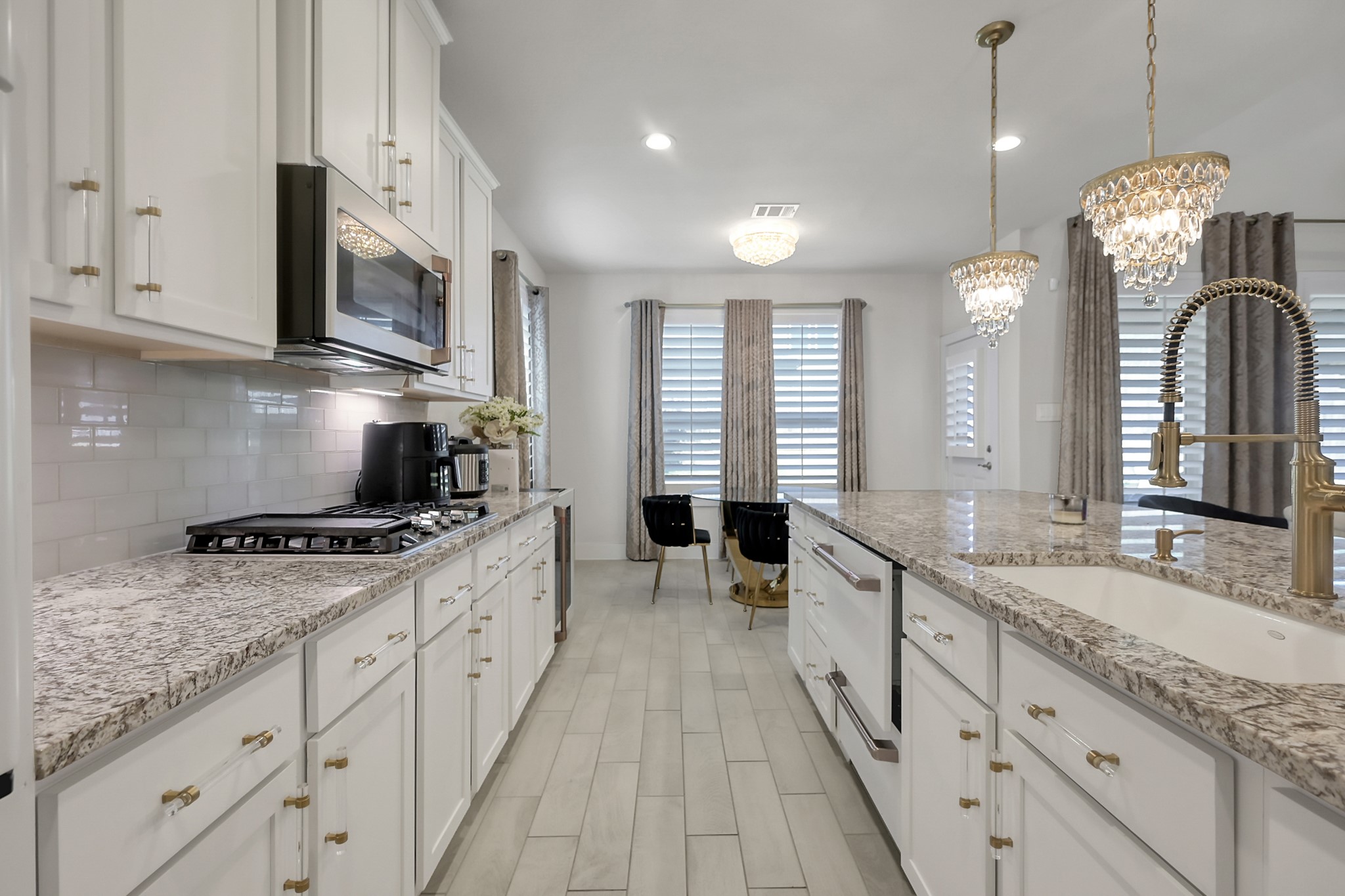 3131 Red Buckeye Lane Conroe, TX 77301 - Photo 12 of 34 a large kitchen with stainless steel appliances granite countertop a lot of counter space and a sink
