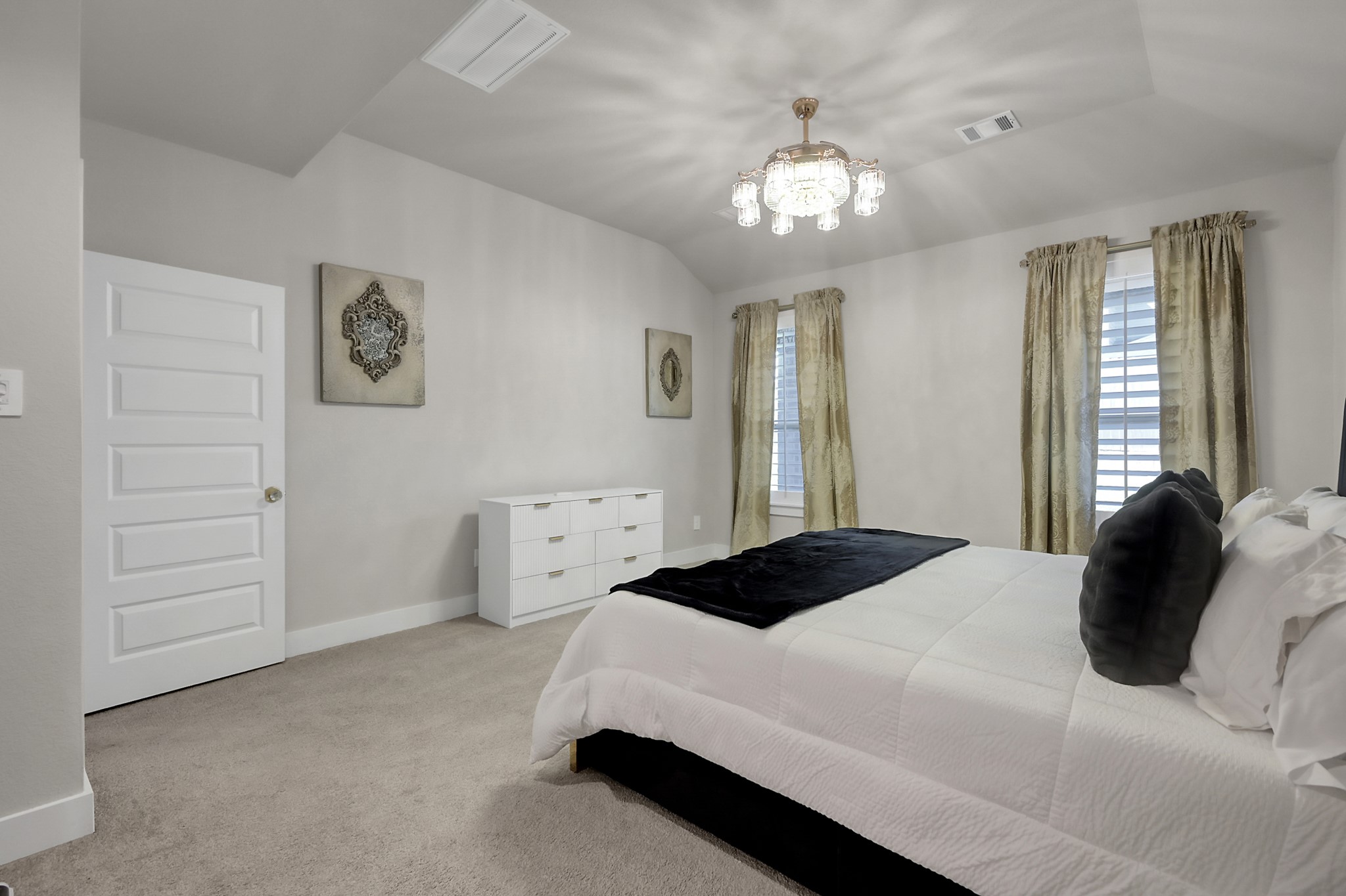 3131 Red Buckeye Lane Conroe, TX 77301 - Photo 16 of 34 a bedroom with a bed and a chandelier