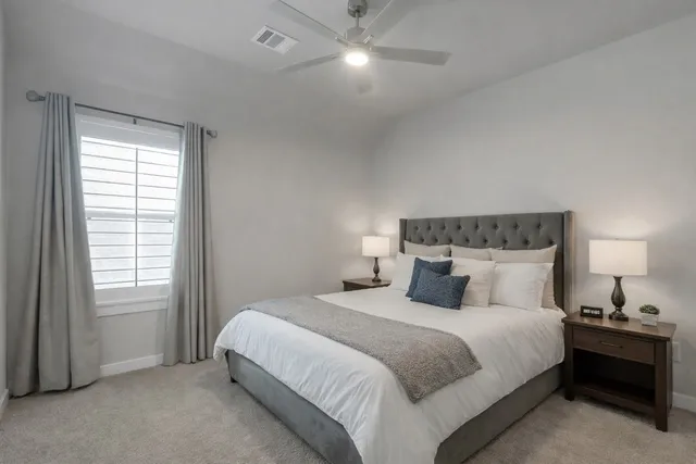 a bedroom with a bed and a night stand