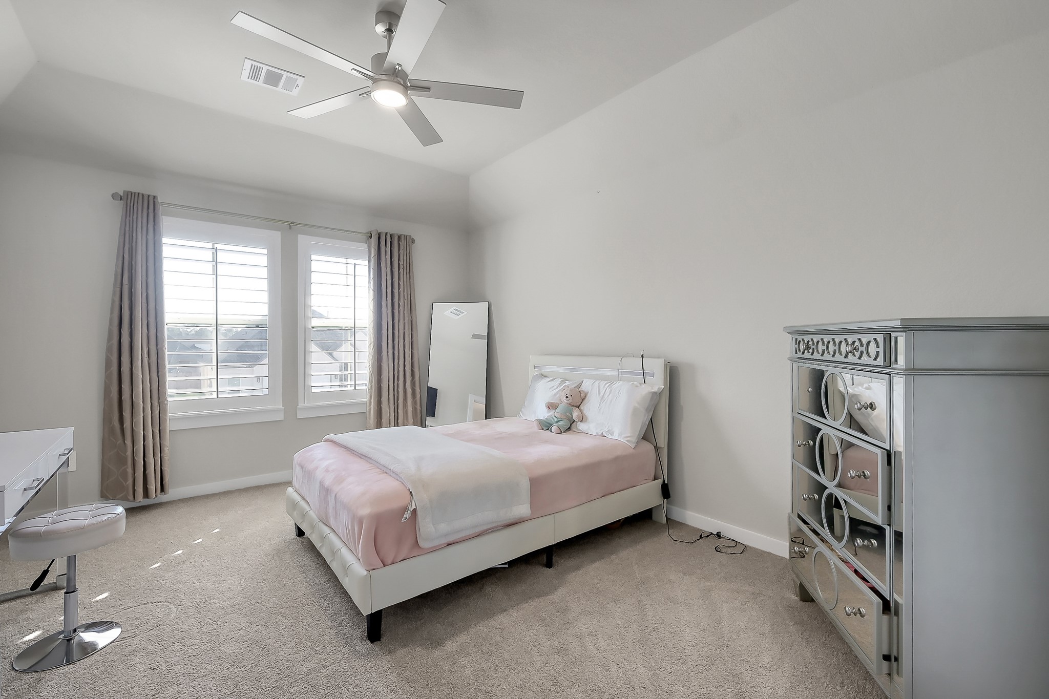 3131 Red Buckeye Lane Conroe, TX 77301 - Photo 23 of 34 a spacious bedroom with a bed and a large window