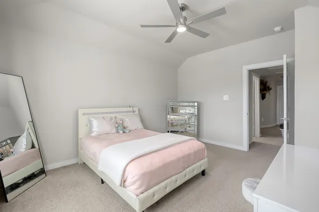 a bedroom with a bed and a couch