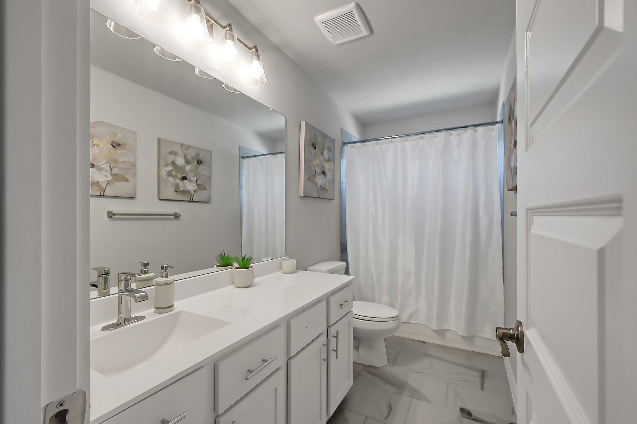 3131 Red Buckeye Lane Conroe, TX 77301 - Photo 28 of 34 a bathroom with a double vanity sink toilet and a mirror