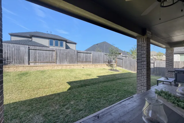 a swimming pool with outdoor seating and yard