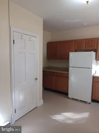 a kitchen with a refrigerator and a washer