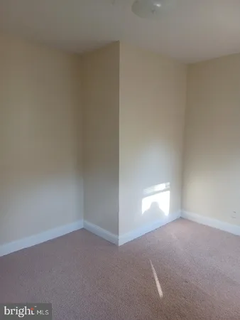 a view of an empty room and a window