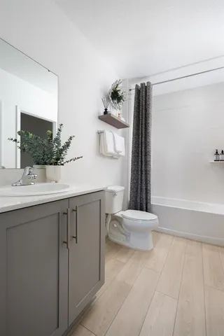 a bathroom with a sink a toilet and tub