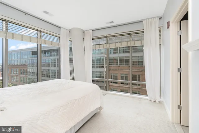 a large bed sitting in front of a window