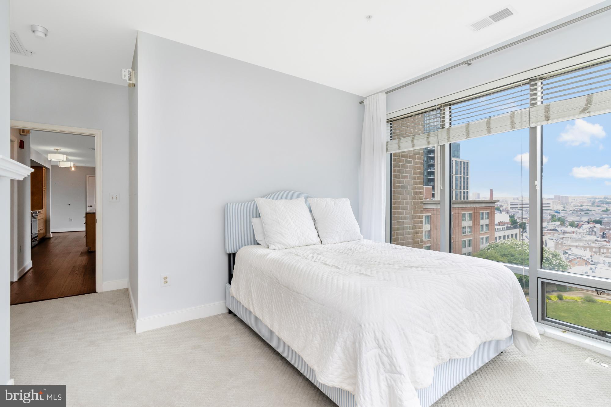 675 President Street, Unit 1406 Baltimore, MD 21202 - Photo 21 of 30 a bedroom with a large bed and a large window