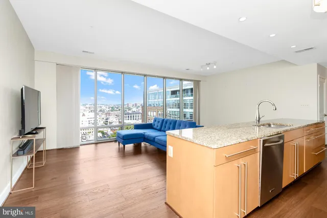 a kitchen with a sink and wooden floor