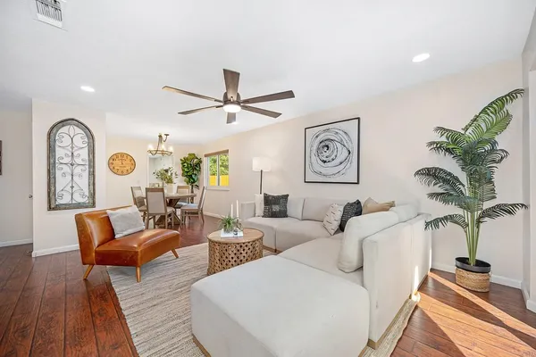 a living room with furniture a fireplace and wooden floor