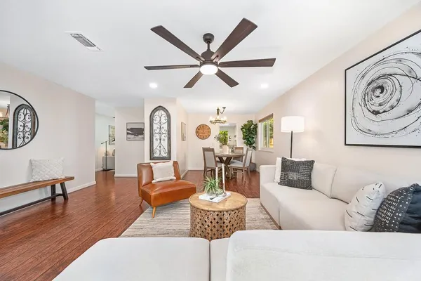 a living room with furniture a fireplace and wooden floor