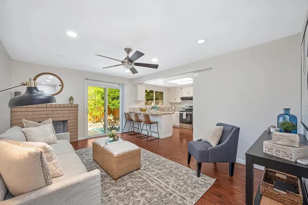 a living room with furniture and kitchen view