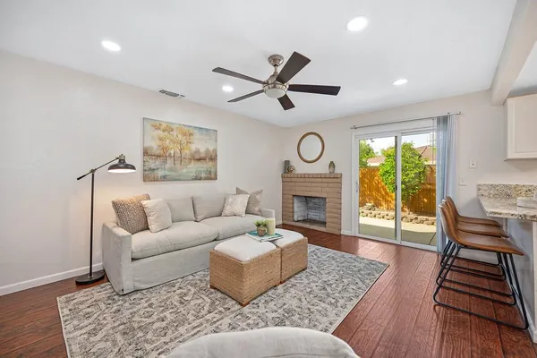 an empty room with a fan and a window