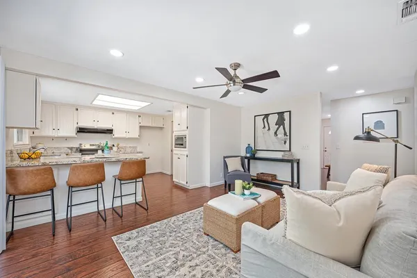 an empty room with a ceiling fan and a mirror