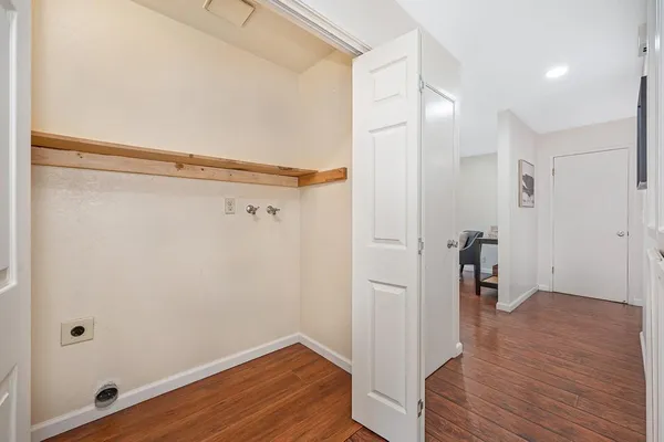 a view of a hallway with wooden floor