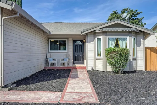 a view of a house with backyard porch and sitting area