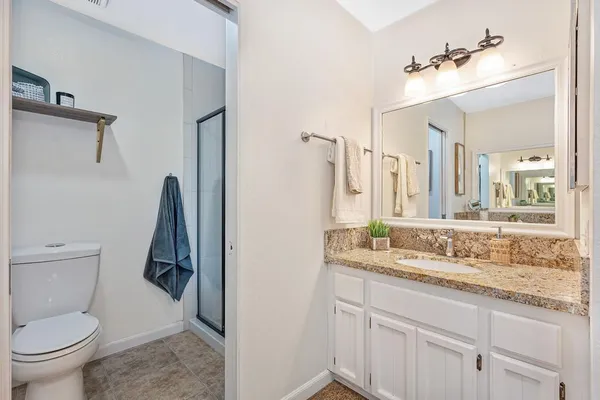 a view of a backyard with table and chairs and potted plants