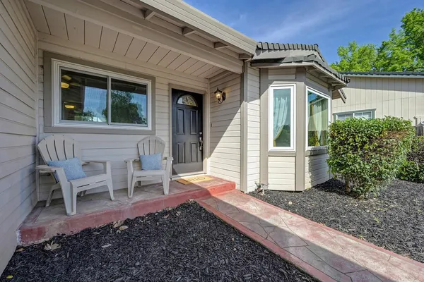 a view of a door and chair in front of a house