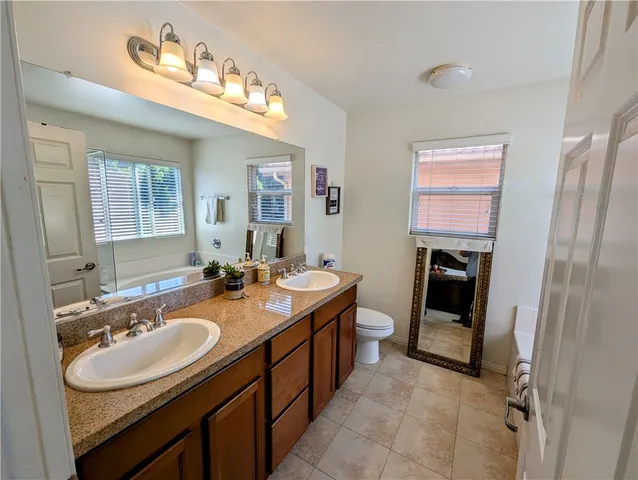 a bathroom with a sink double vanity granite and a mirror
