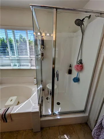 a bathroom with a tub and shower