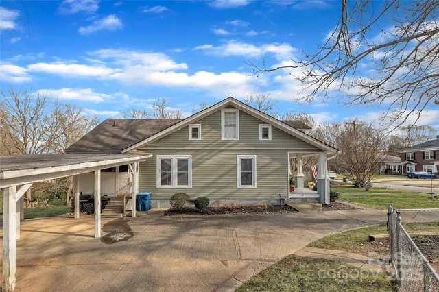 a view of a house with wooden fence
