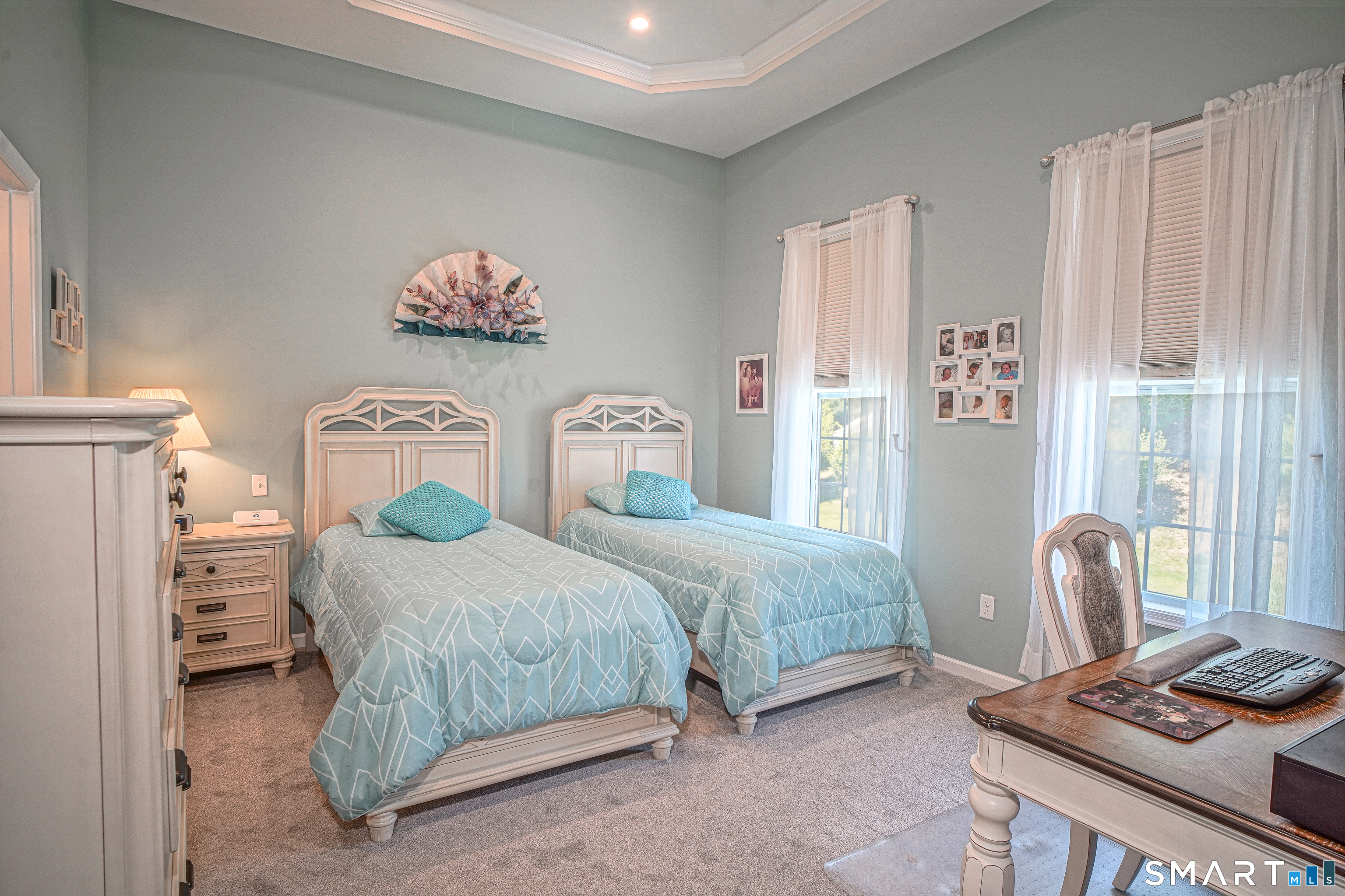 6 Lilac Lane, Unit 6 Prospect, CT 06712 - Photo 15 of 40 First-floor Primary bedroom with hardwood floors and a decorative tray ceiling.
