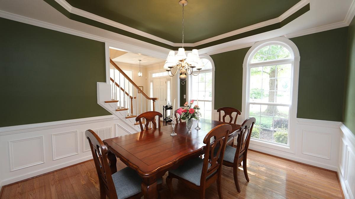 10705 Chesson Drive Raleigh, NC 27614 - Photo 4 of 30 Large dining room with tray ceiling, crown and chair rail molding, wainscoting, and tons of natural light. Dining Room