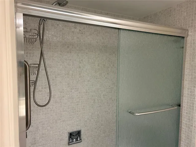 a bathroom with a glass shower door