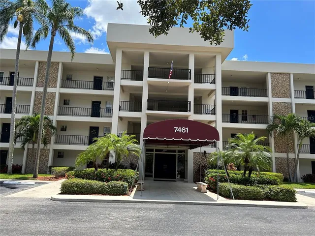 a front view of a building with a garden