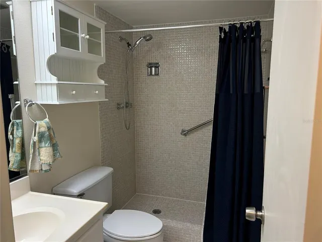 a bathroom with a toilet and a shower