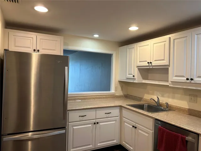 a kitchen with a sink and a refrigerator