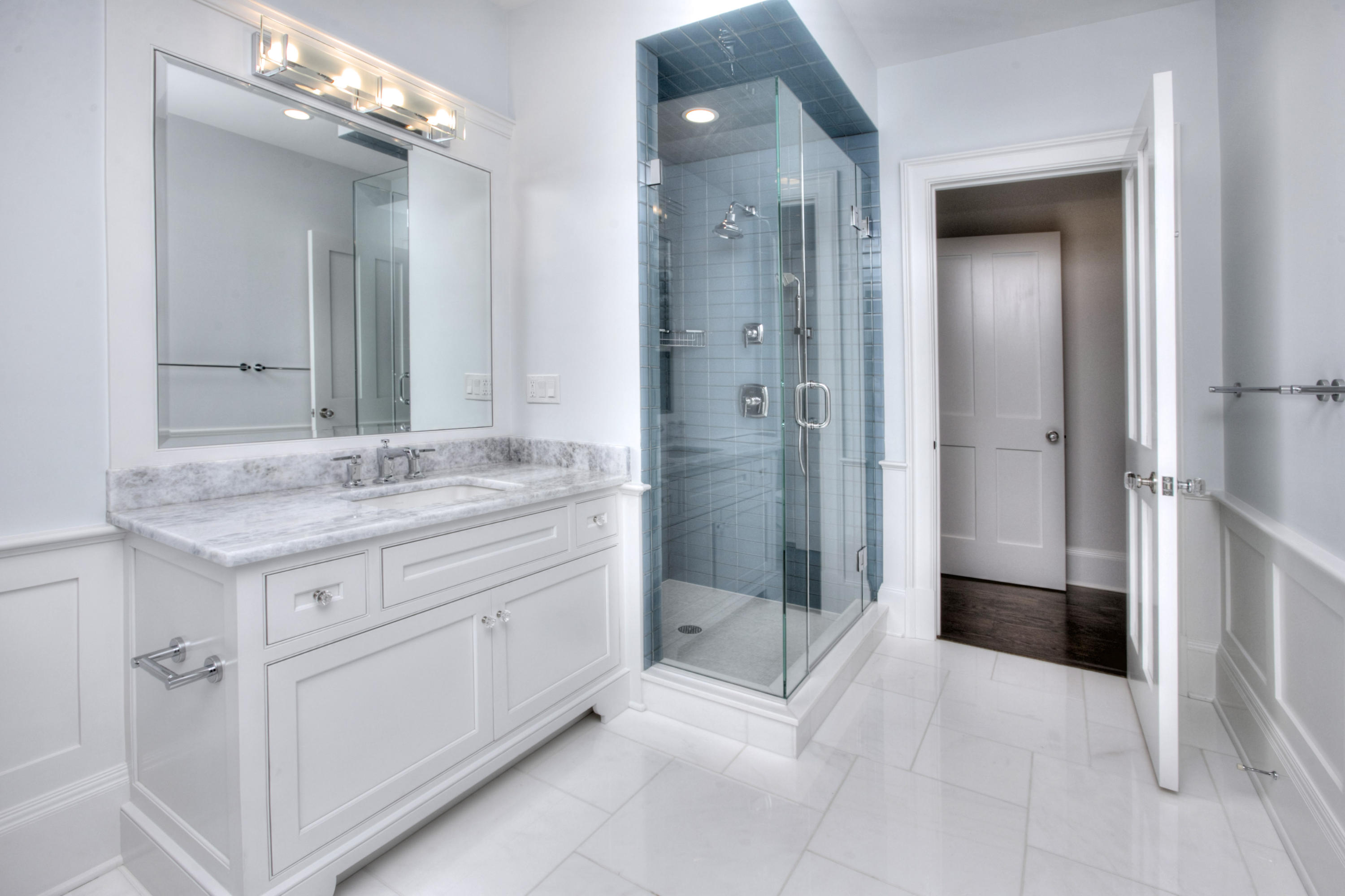 11 Sunswyck Road Darien, CT 06820 - Photo 18 of 25 a bathroom with a granite countertop sink a mirror and a shower