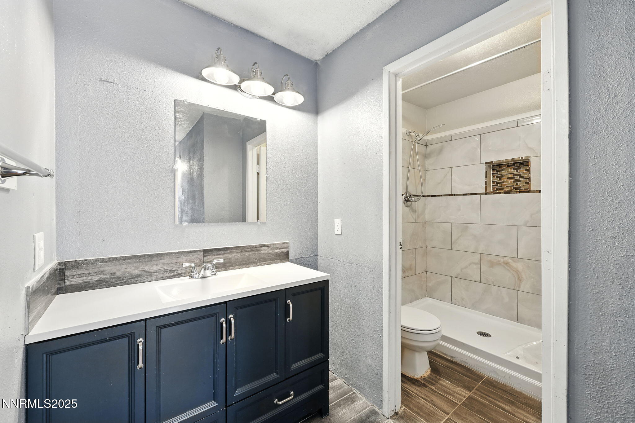 2101 Highview Court, Unit 9 Reno, NV 89512 - Photo 11 of 15 a bathroom with a double vanity sink toilet and shower