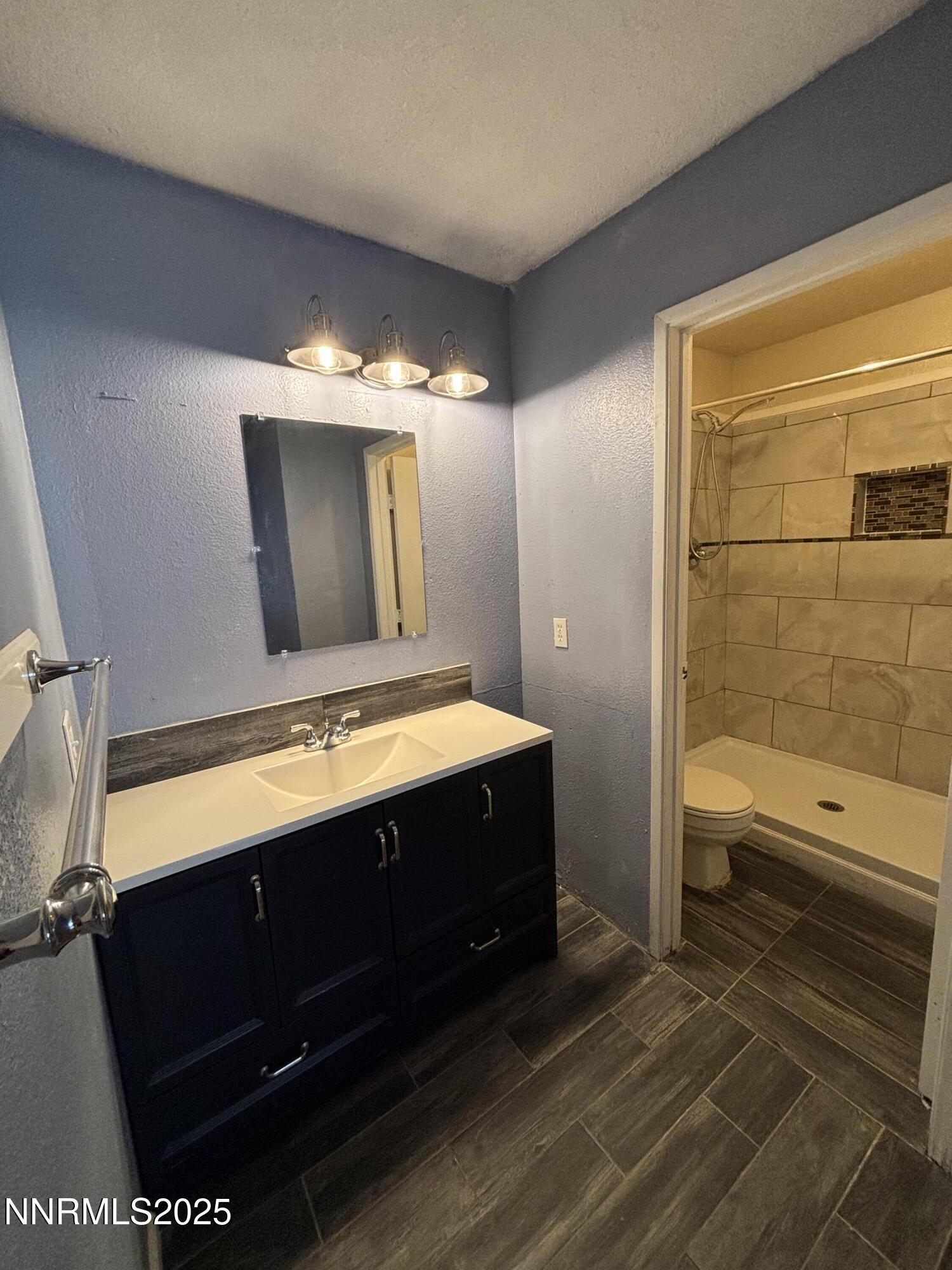 2101 Highview Court, Unit 9 Reno, NV 89512 - Photo 3 of 15 a bathroom with a sink a toilet and shower