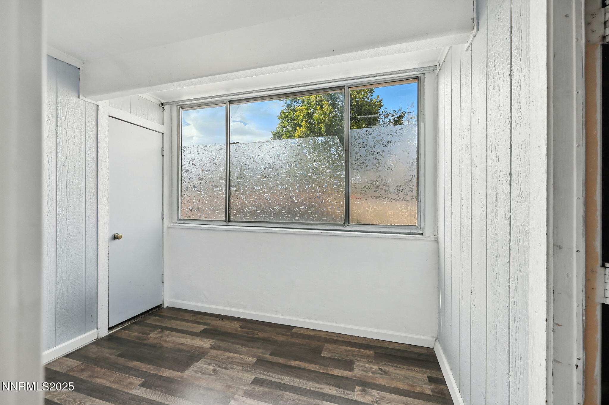 2101 Highview Court, Unit 9 Reno, NV 89512 - Photo 6 of 15 a view of an empty room with wooden floor and a window