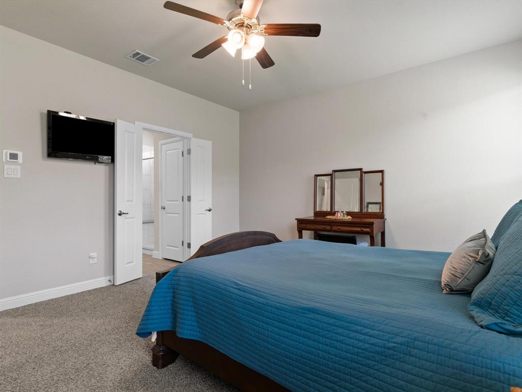 270 Lunayena Road Rhome, TX 76078 - Photo 30 of 37 The spacious primary bedroom offers a comfortable retreat with ample natural light and a well-proportioned layout, providing a private space to unwind at the end of the day.