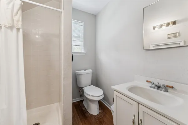 a kitchen with stainless steel appliances granite countertop white cabinets sink and a microwave