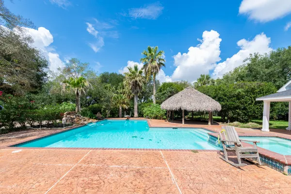 a view of a backyard with a garden and seating area