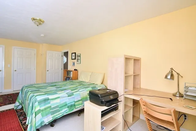 a bedroom with a bed and a table