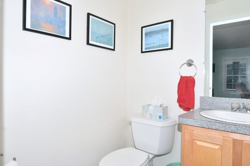 18 D Street Hull, MA 02045 - Photo 10 of 18 a bathroom with a granite countertop toilet sink and mirror