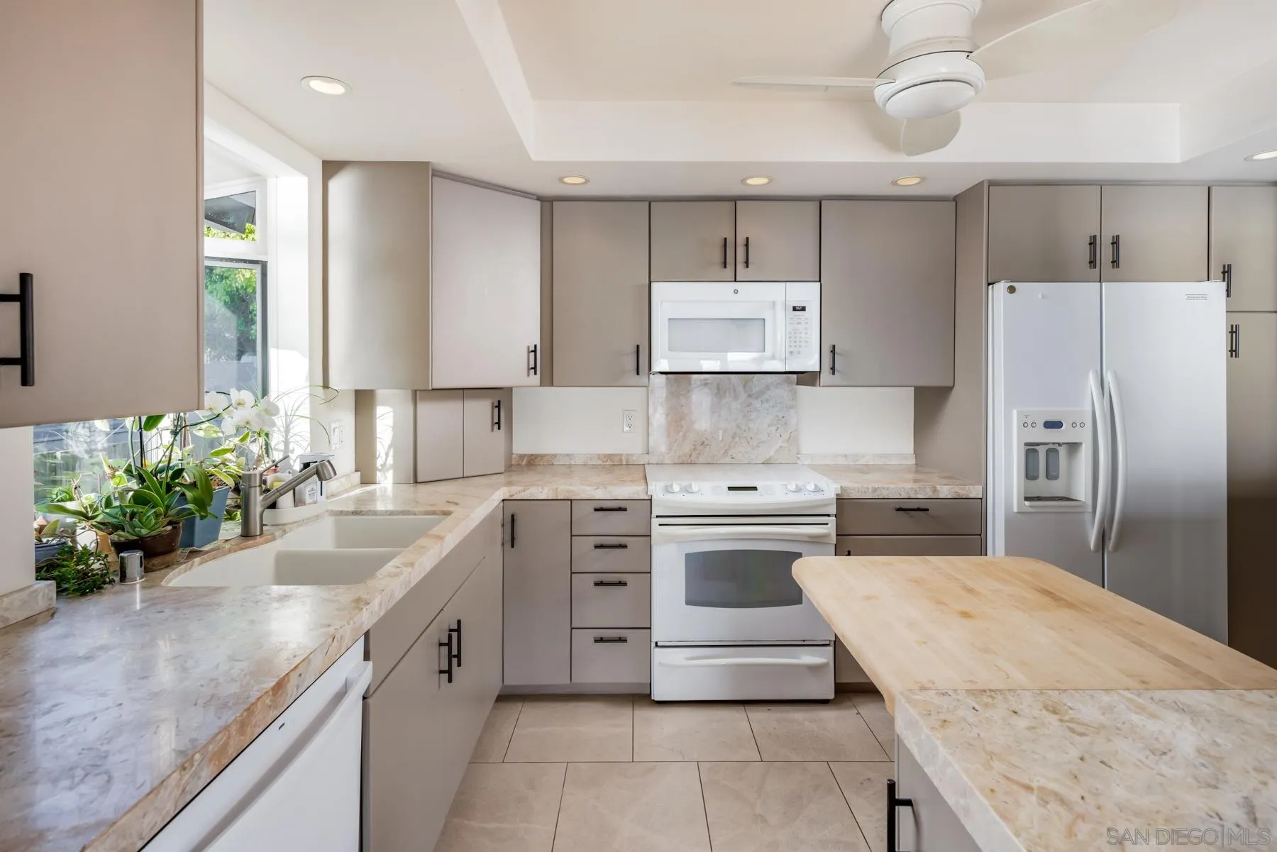 1036 Neptune Avenue Encinitas, CA 92024 - Photo 12 of 34 a kitchen with kitchen island a sink stainless steel appliances and cabinets