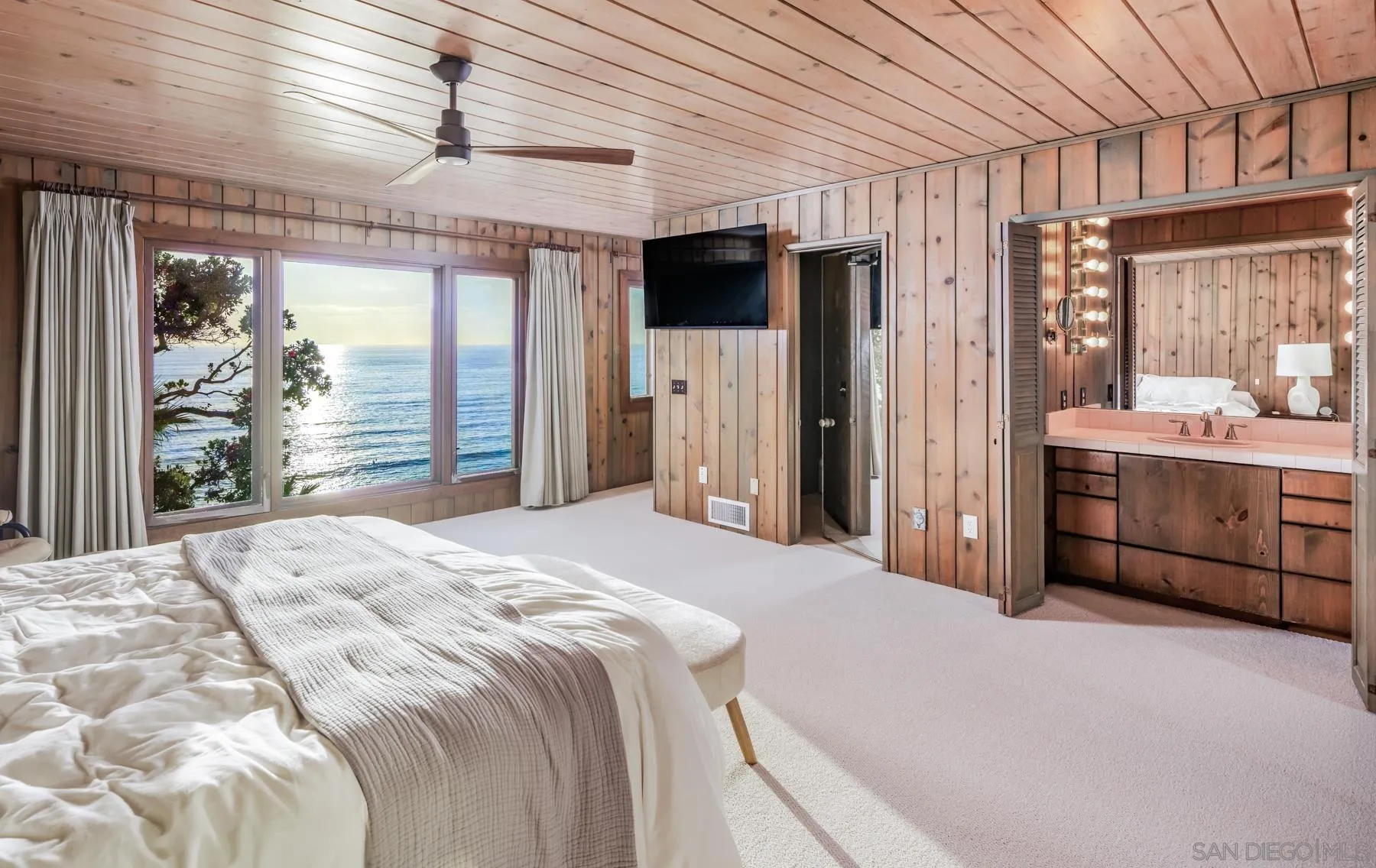 1036 Neptune Avenue Encinitas, CA 92024 - Photo 15 of 34 a spacious bedroom with a large bed and a large window