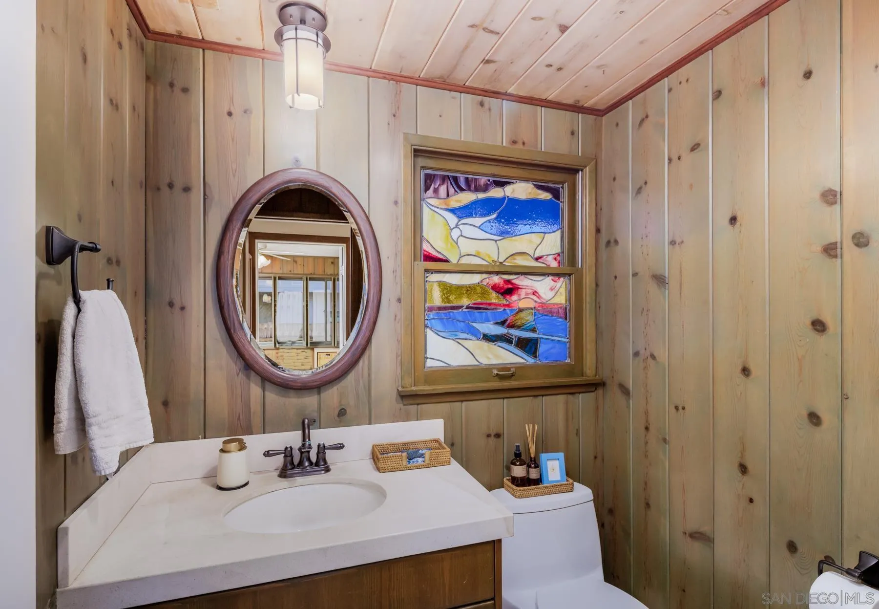 1036 Neptune Avenue Encinitas, CA 92024 - Photo 18 of 34 a bathroom with a sink a vanity and a mirror