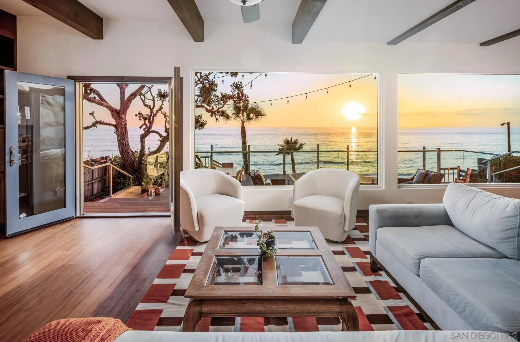 1036 Neptune Avenue Encinitas, CA 92024 - Photo 6 of 34 a living room with furniture a rug and a floor to ceiling window