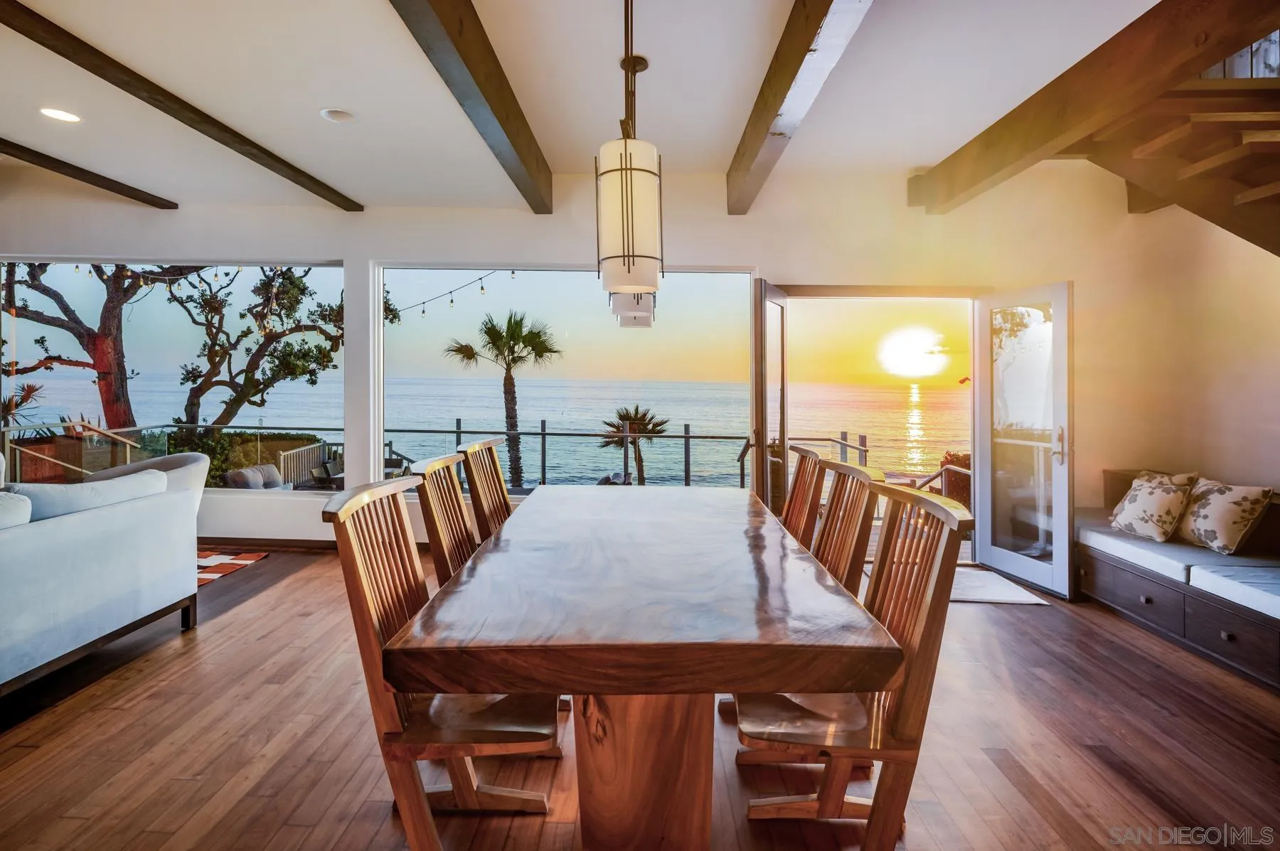1036 Neptune Avenue Encinitas, CA 92024 - Photo 9 of 34 a view of a dining room with furniture window and wooden floor