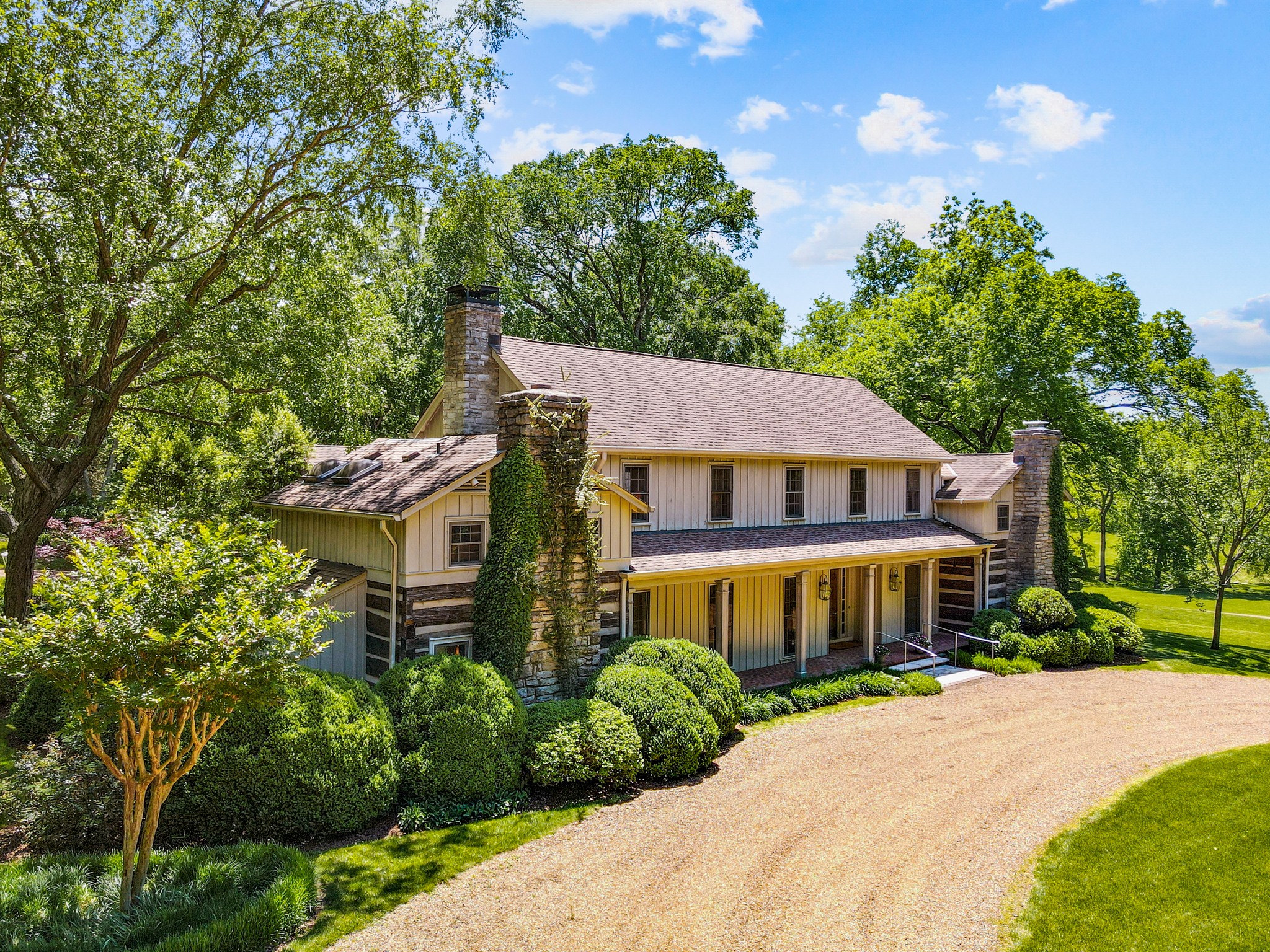 370 Vaughn Road Nashville, TN 37221 - Photo 2 of 27 a front view of a house with a garden
